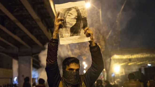 Tehran protester holding up picture
