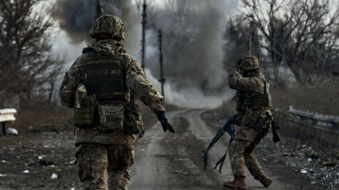 Ukrainian soldiers run in the Donbas region, February 2023