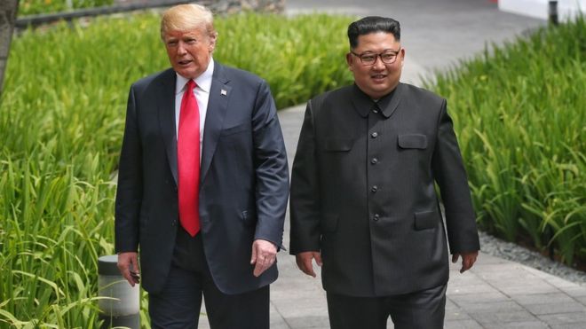 Donald Trump and Kim Jong-un walk beside each other at the Capella hotel in Singapore