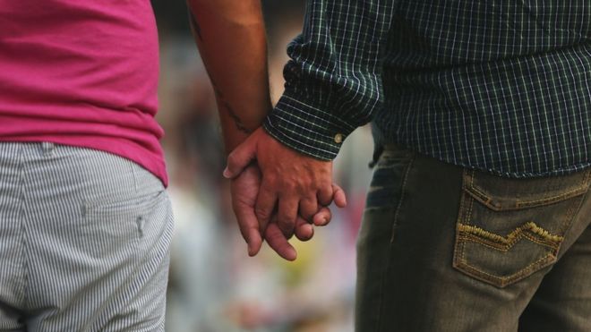 Gay couple holding hands, file pic