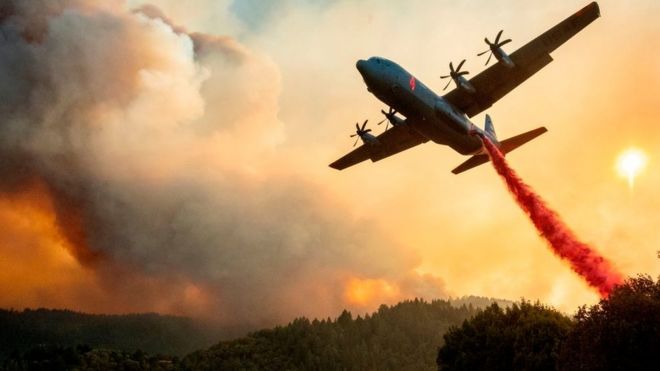 An aircraft drops fire retardant on a ridge during the Walbridge fire in California on August 20, 2020.