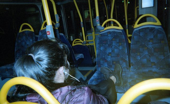 A bus passenger and rows of empty seats
