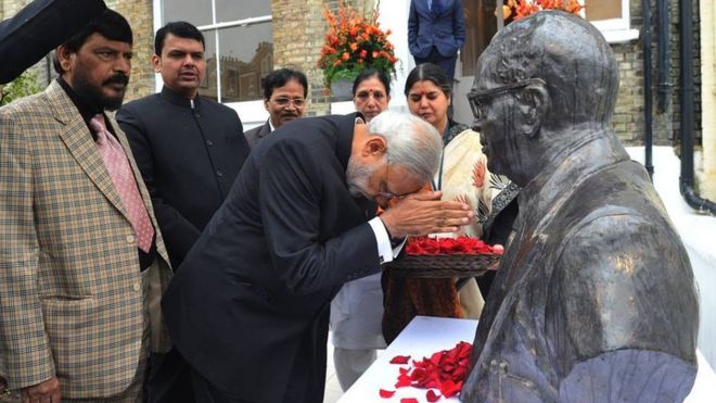 Indian Prime Minister Narendra Modi bowing by a bust of Dr Ambedkar