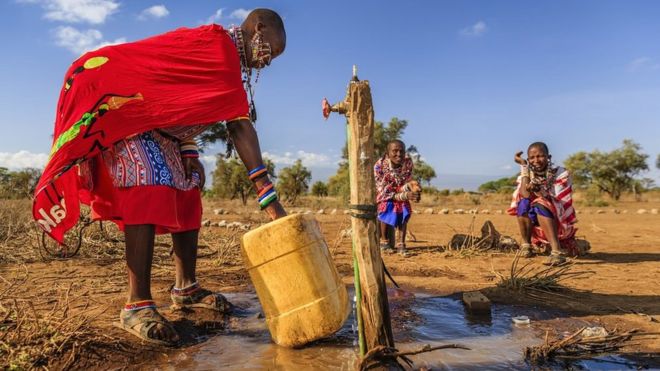 A woman from the Maasai tribe collects water in Kenya