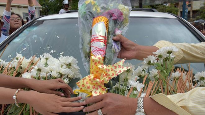 Камбоджийцы возлагают цветы к машине с телом политического аналитика Кем Лея, застреленного в воскресенье в Пномпене (10 июля)