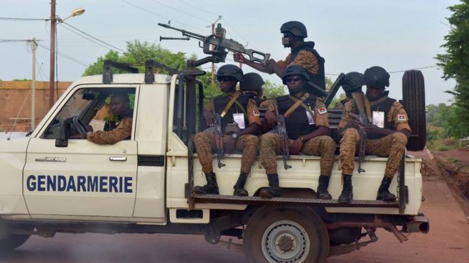 Burkinabe gendarmes sitting on their vehicle in the city of Ouhigouya in the north of the country in October 2018