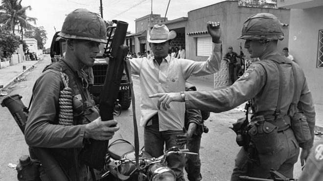US Army Airborne troops search a suspect during the occupation of the Dominican Republic in 1965.