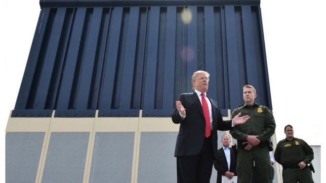 US President Donald Trump inspects a prototype of the wall he hopes to build across the US-Mexico border
