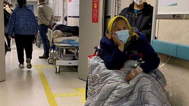 A patient with Covid-19 waits in a hallway at a hospital in China's northeastern city of Tangshan