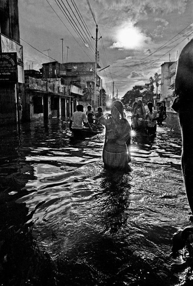 Женщина пробирается во время наводнения, Камалапур, Дакка, Бангладеш. 1988.