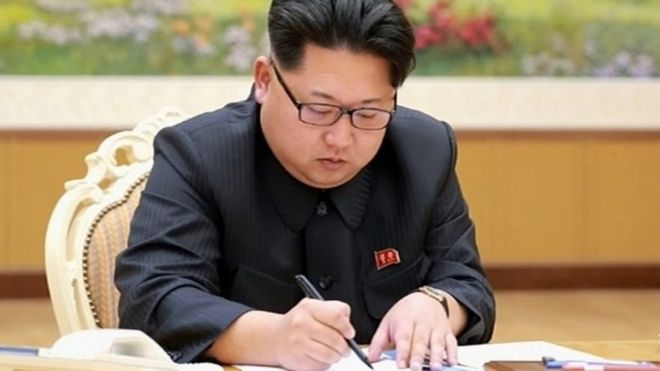 На этом снимке, снятом с северокорейского телевидения и выпущенном южнокорейским информационным агентством Yonhap 6 января 2016 года, северокорейский лидер Ким Чен Ын подписывает документ о проведении испытания водородной бомбы в Пхеньяне.