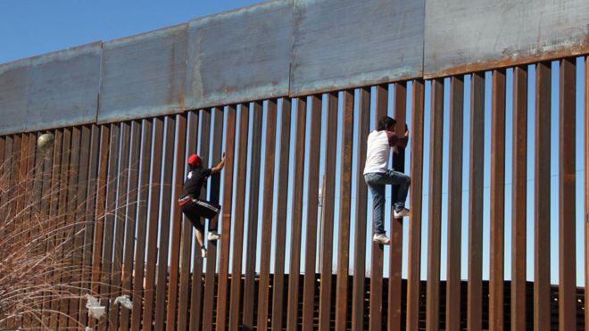 Мальчики поднимаются на пограничный забор в Сьюдад-Хуарес