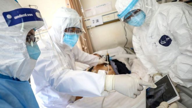 Doctors examining patient in Wuhan