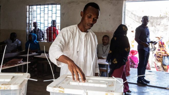 A man casts his ballot for the presidential election at a polling station of Mitsoudje