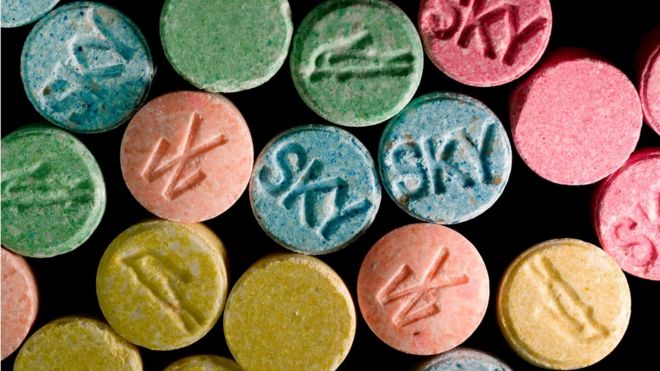 Multi-coloured ecstasy pills marked with various logos. Street slang/terms for ecstasy