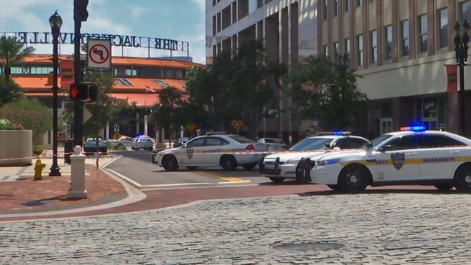 Police cars block a street leading to the Jacksonville Landing area in downtown Jacksonville, Florida, 26 August 2018