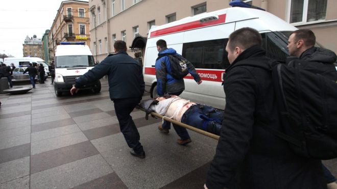 Men carry an injured person on a stretcher outside Technological Institute metro station in Saint Petersburg on April 3, 2017.