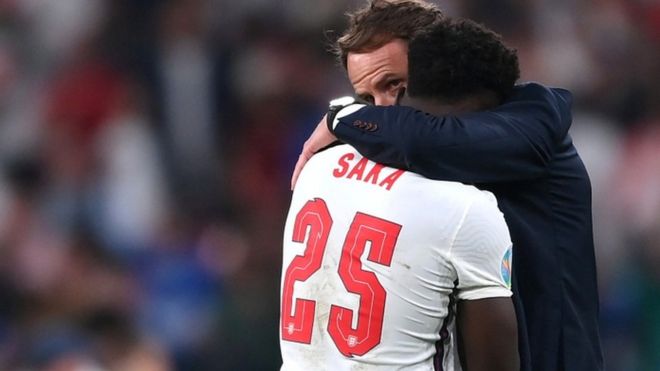 England"s Bukayo Saka with manager Gareth Southgate after the match