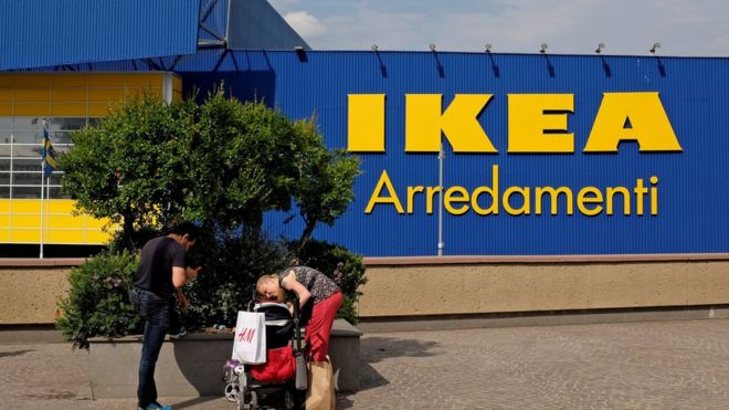 A family stop in front of an Ikea shop in a shopping park in Rome, Italy on 19 May 2017.