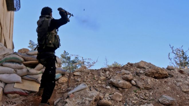 A rebel fighter fires towards pro-government positions, west of the northern Syrian city of Aleppo, 9 December