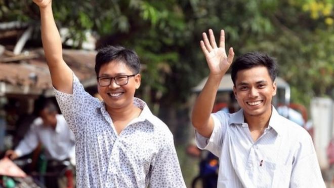 Reuters reporters Wa Lone and Kyaw Soe Oo gesture as they walk free outside Insein prison after receiving a presidential pardon in Yangon, Myanmar