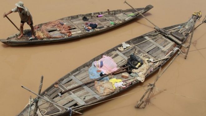 Камбоджийский рыбак гребет на лодке на реке Меконг в Пномпене, Камбоджа, 22 сентября 2015 года