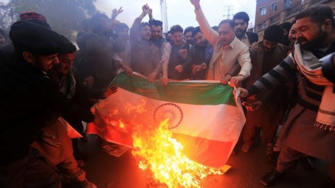 Men in Pakistan burn Indian flags after an Indian military incursion into Pakistani territory