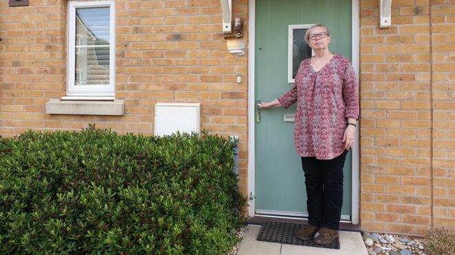 Denise Sullivan standing outside her front door