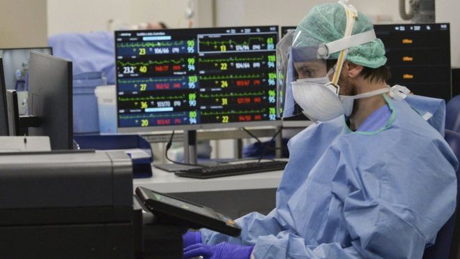Medical staff at a newly set up intensive care unit in the Poliambilanza hospital in Brescia, Italy, 30 March 2020