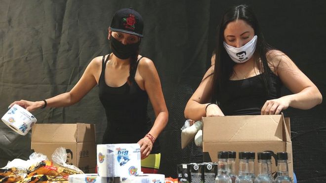 Employees of the clothing brand owned by El Chapo's daughter box up food supplies
