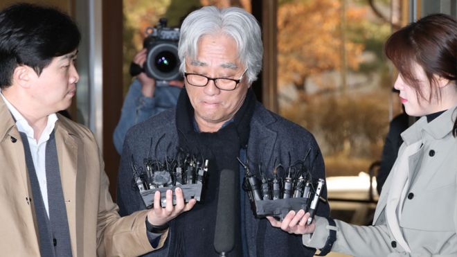 Theatre director Lee Yoon-taek is surrounded by reporters as he appeared for police questioning on 17 March