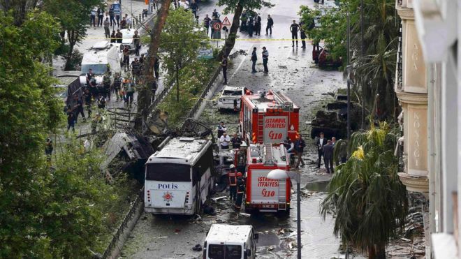 Fire engines stand beside a Turkish police bus which was targeted in Istanbul