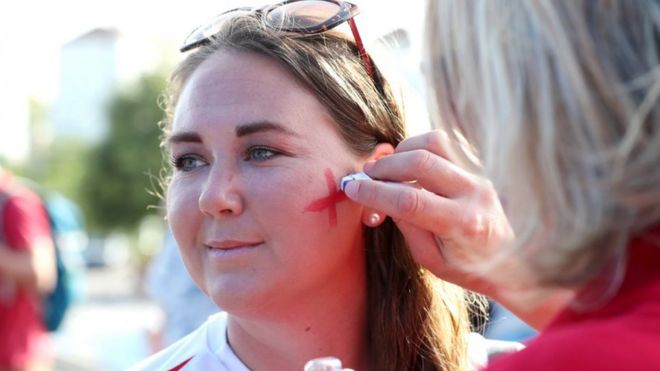 Woman has England flag painted on her cheek