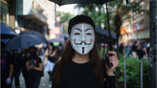 In this picture taken on October 1, 2019, a protester wears a Guy Fawkes mask to cover her face, popularised by the V For Vendetta comic book film, in Hong Kong
