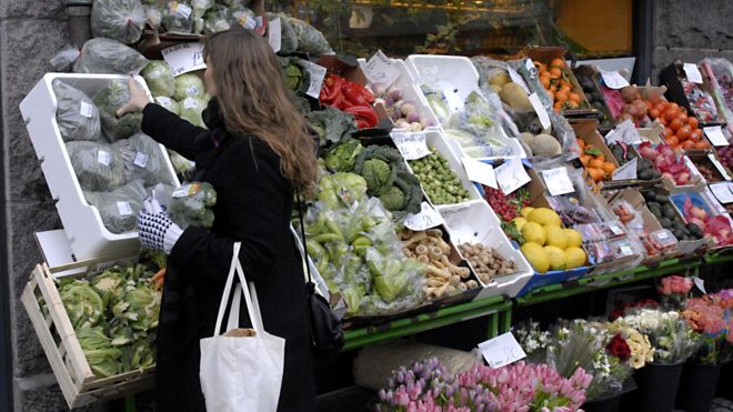 Woman in Denmark shops for fruit and veg