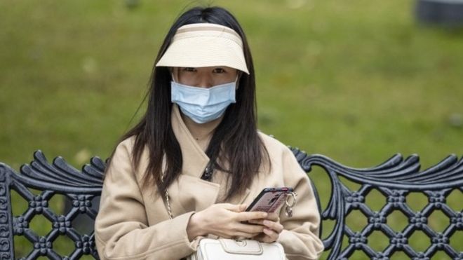 A woman wears a mask in Guangzhou, China. Photo: 4 February 2020