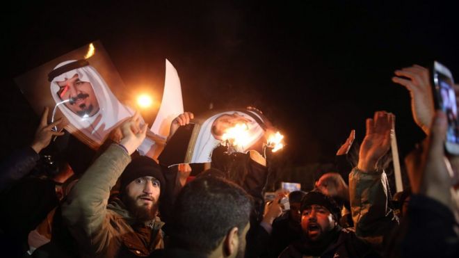 Iranian protestor burn pictures of a member of the Saudi royal family in front of the Saudi Arabia embassy in Tehran, Iran on 2 January 2016