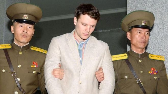 Otto Warmbier is escorted by N Korean guards (image released March 2016)