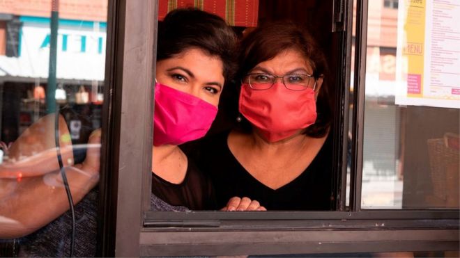 Vanessa Zubia-Meza and her mother Margie Zubia are pictured in the window of their new restaurant called El Paseo on May 18, 2020 in downtown El Paso, Texas