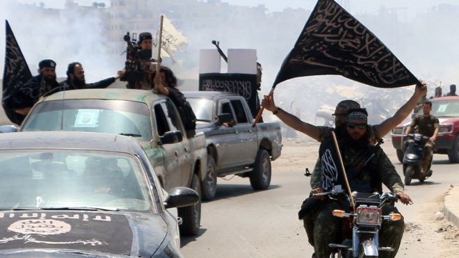 Fighters from Al-Nusra Front drive in Aleppo flying Islamist flags as they head to a front line, on May 26, 2015