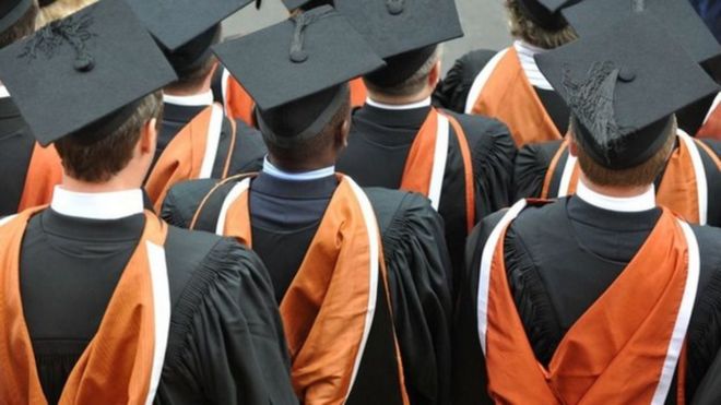 University students wey wear graduation gown and cap
