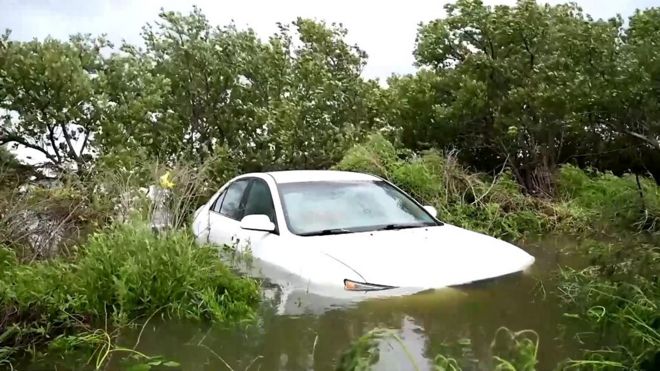 Car partially submerged in flood water