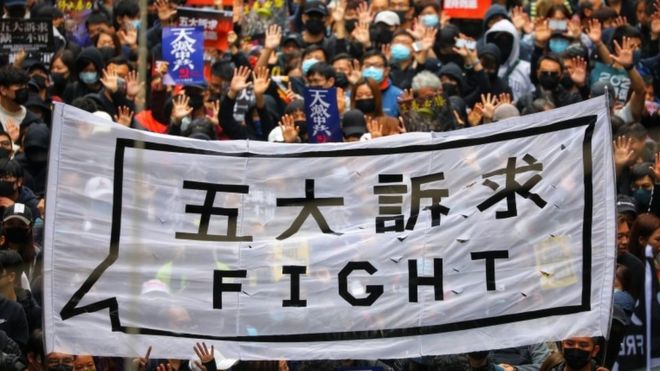 People hold a banner reading "fight" as they take part in an anti-government rally on New Year's Day in Hong Kong