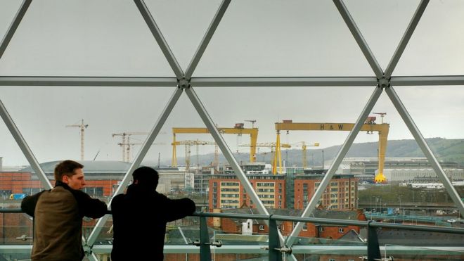 Местные жители смотрят на Белфаст со смотрового купола над торговым комплексом на площади Виктории