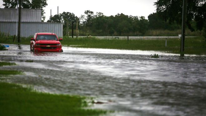 A car near Vermilion Bay is seen partially submerged in waters brought by Hurricane Laura approaching Abbeville, Louisiana, 26 August 2020