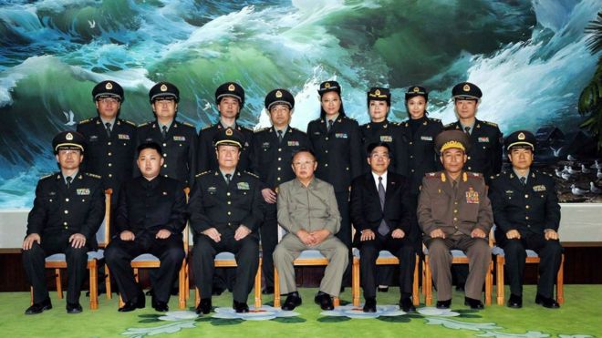 Северокорейский лидер Ким Чен Ир (передний ряд-C) и его сын Ким Чен Ын (передний ряд-2 L) позируют с китайскими офицерами в октябре 2010 года