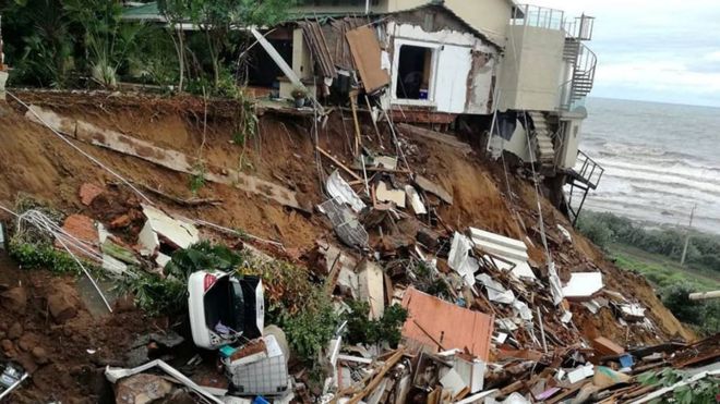 A destroyed house by the beach