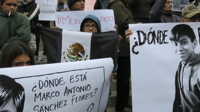Dozens of people protest with signs reading "Where is Marco Antonio Sanchez?" at the Angel of Independence in Mexico City, Mexico, 28 January 2018.