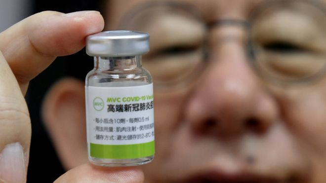 Charles Chen, Chief Executive Officer of Taiwans vaccine maker Medigen Vaccine Biologics Corp (MVC), poses for photographs with a vaccine sample at its headquarters in Taipei on June 16, 2021.