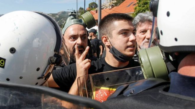 Demonstrators argue wit police during one protest against enthronement of Bishop Joanikije for Cetinje